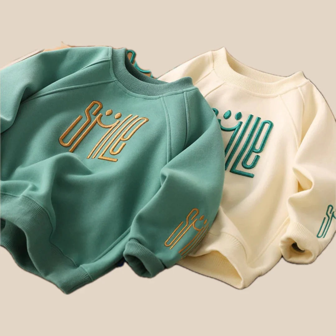Unisex Kinderpullover mit einem fröhlichen Smile-Design