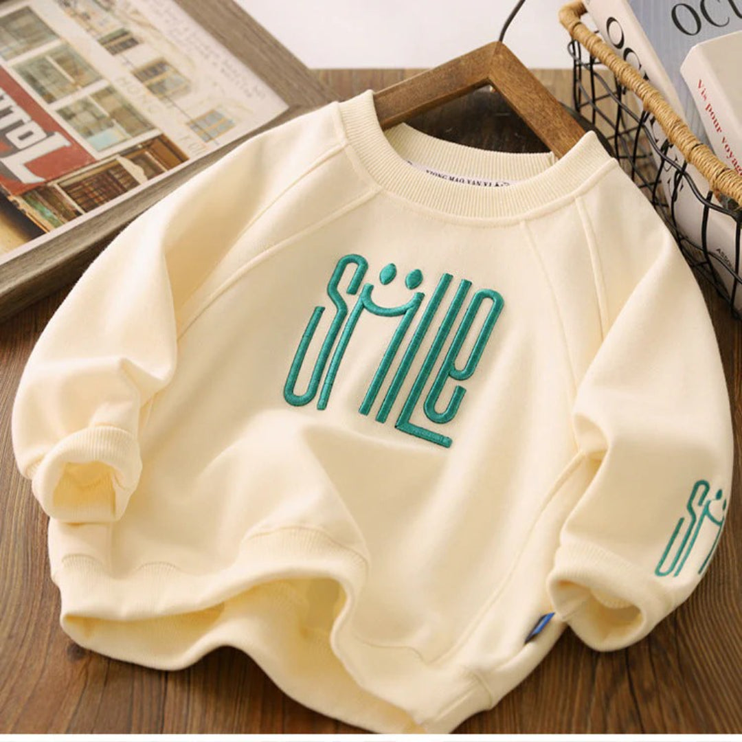 Unisex Kinderpullover mit einem fröhlichen Smile-Design